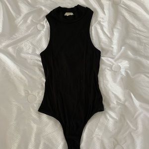 Black body suit with a crisscrossing back